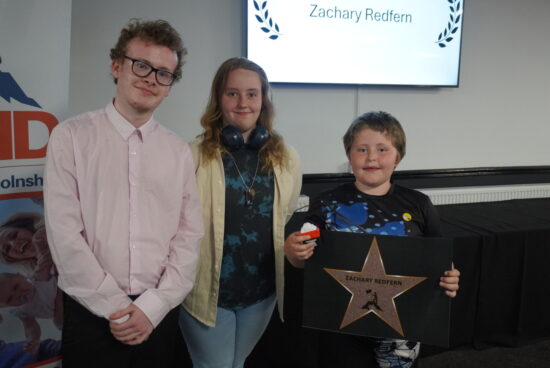Linkage students Temperance and Oliver presenting the 2025 Friendship SEND award to Zackary.